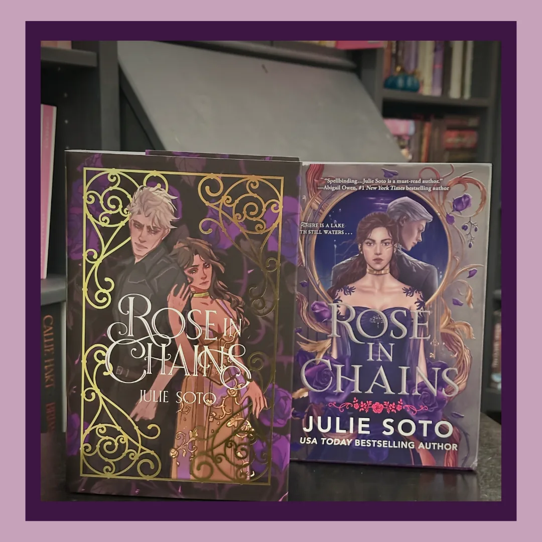 Rose in Chains by Julie Soto, two of three editions. A dark purple hardcover with gold scrollwork and a blue hardcover with the standard cover, on a shelf.
